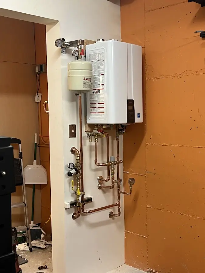 Plumbing technician inspecting water heater connections in Pahrump